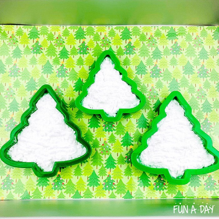 Christmas tree cookie cutters filled with baking soda.