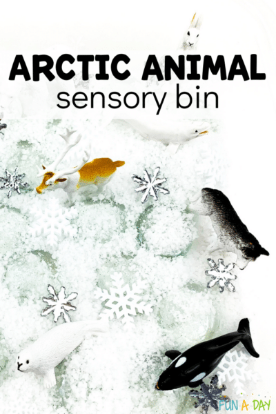 Instant snow, snowflake confetti, and arctic animals in a sensory bin. Text that reads arctic animal sensory bin.