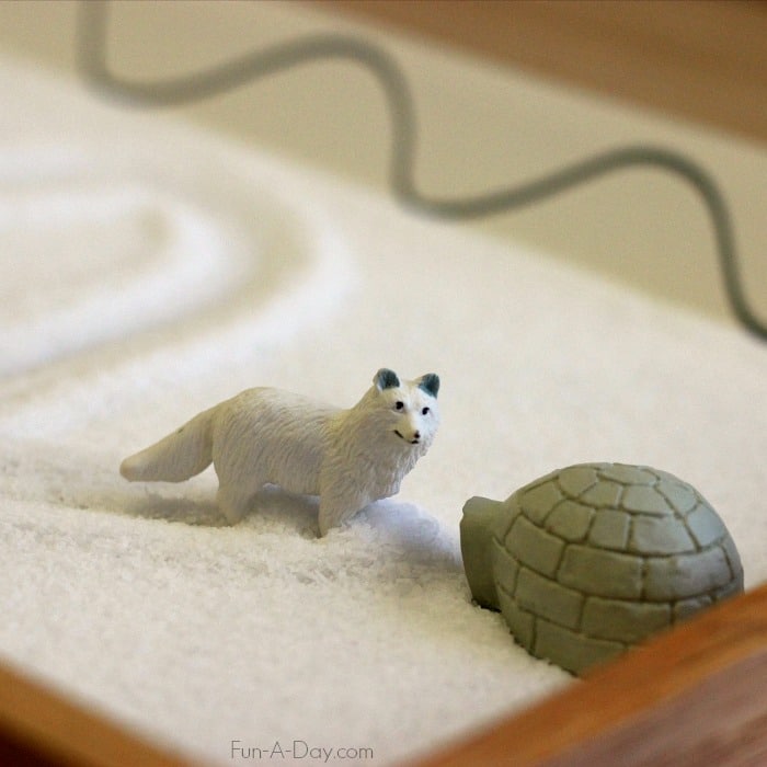 arctic fox and igloo toys in salt writing tray