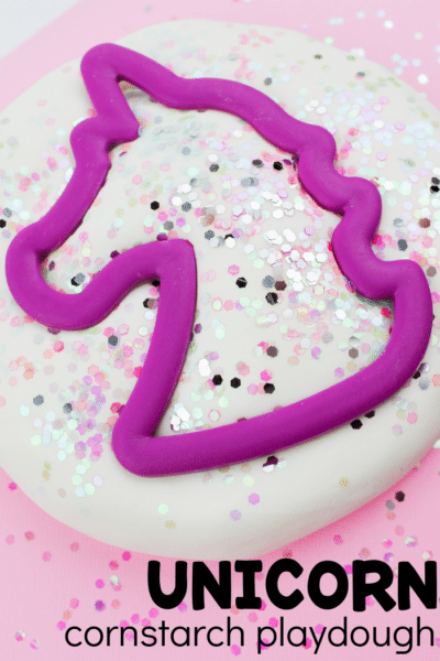 Unicorn cookie cutter in unicorn dough with text that reads unicorn cornstarch play dough.