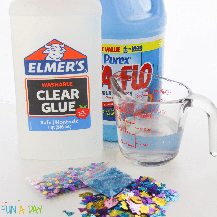 ingredients for birthday slime which includes Elmer's clear glue, liquid starch, a measuring cup with 1/2 cup of water, and birthday confetti.