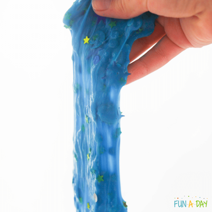 hand stretching blue slime