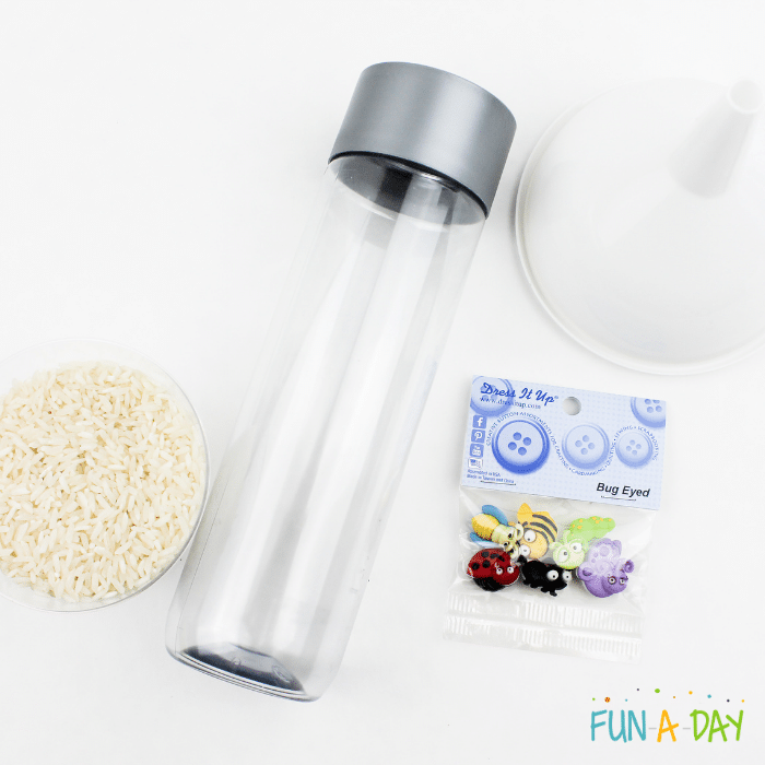 Ingredients used to create the insect sensory bottle which include rice, clear bottle, small bug buttons, and a funnel.