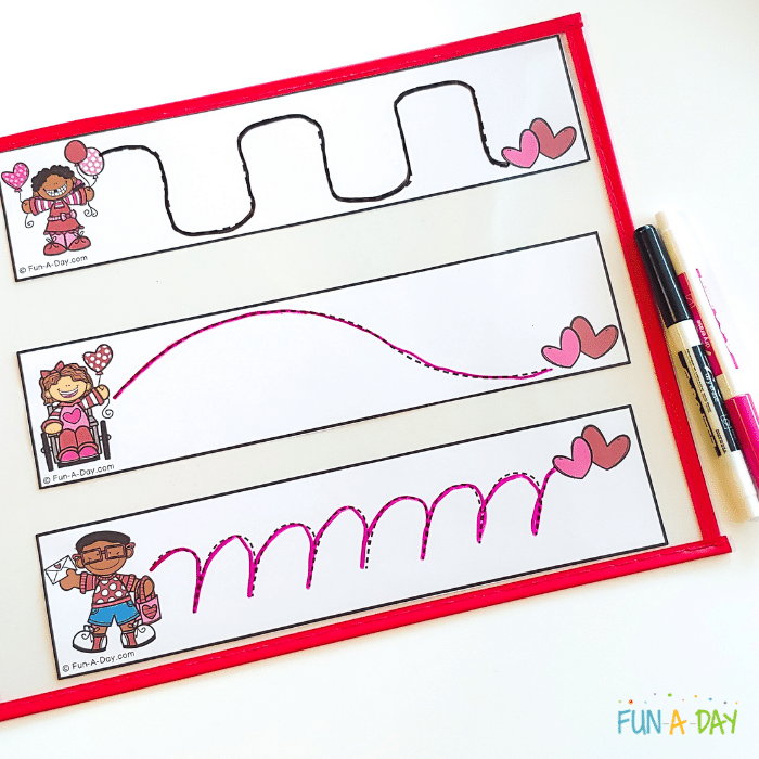 3 valentine tracing strips in a dry erase pocket with two dry erase markers