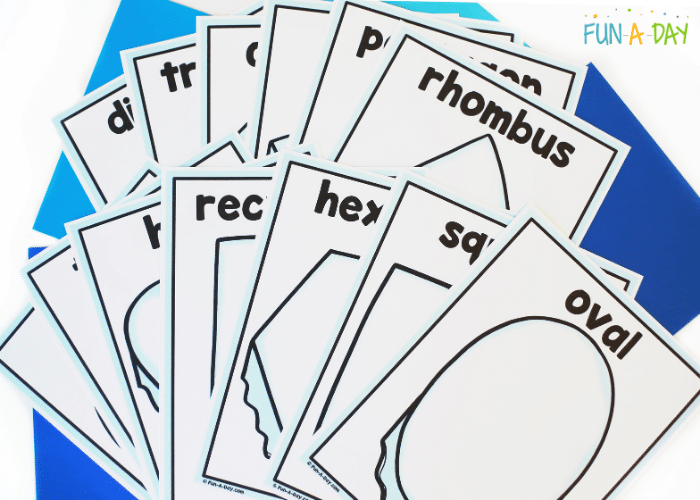 Printable shape mats fanned out over blue background pages.