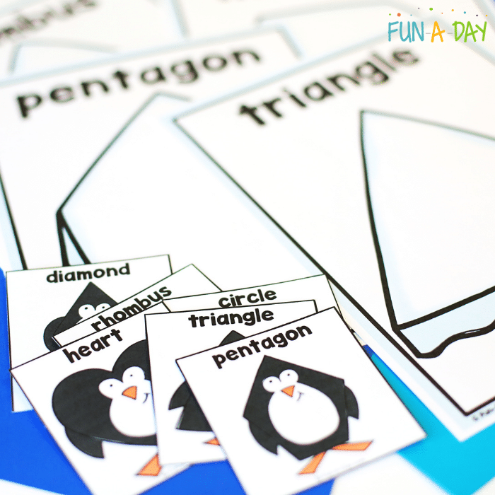 Fanned out Iceburg shape mats and penguin shape cards.