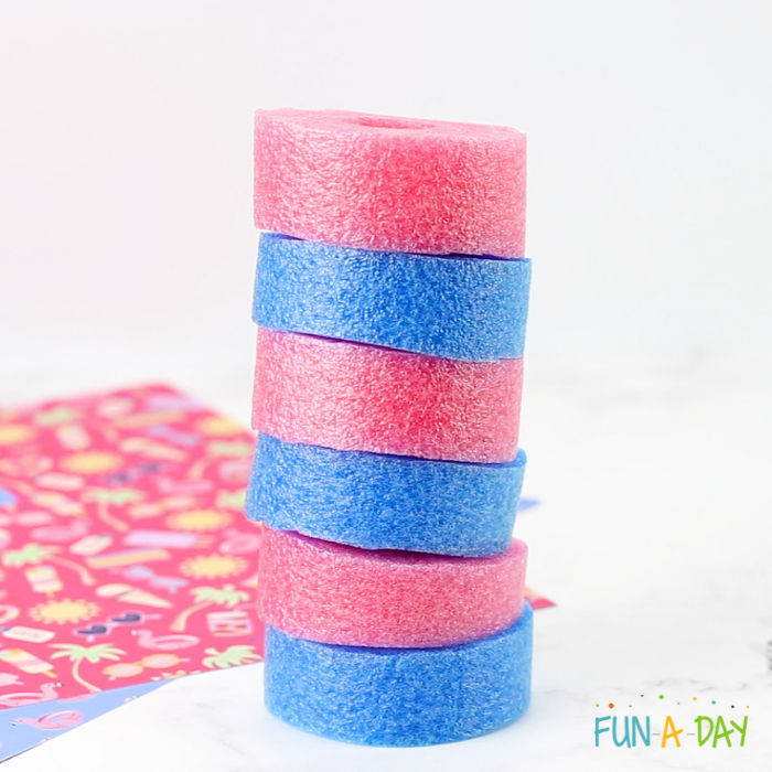 Pink and blue pool noodle pieces in a pattern