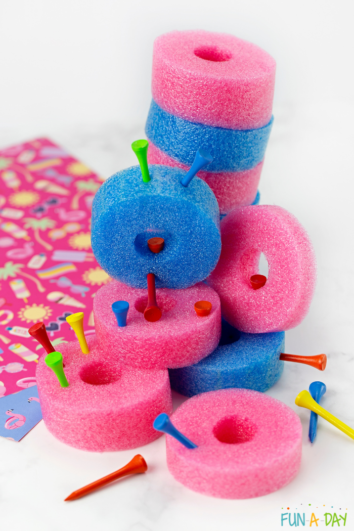 Pink and blue pool noodle pieces paired with golf tees