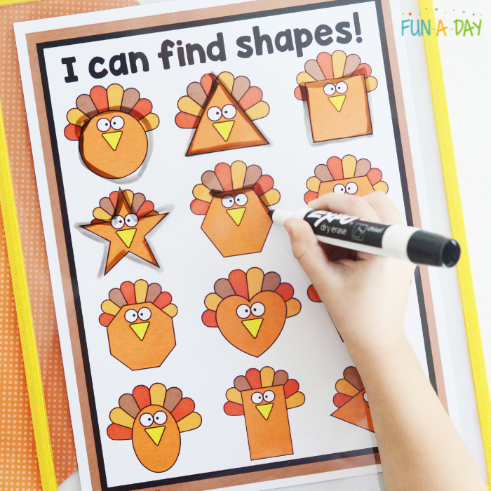 preschool hand tracing over turkey shapes with dry erase marker