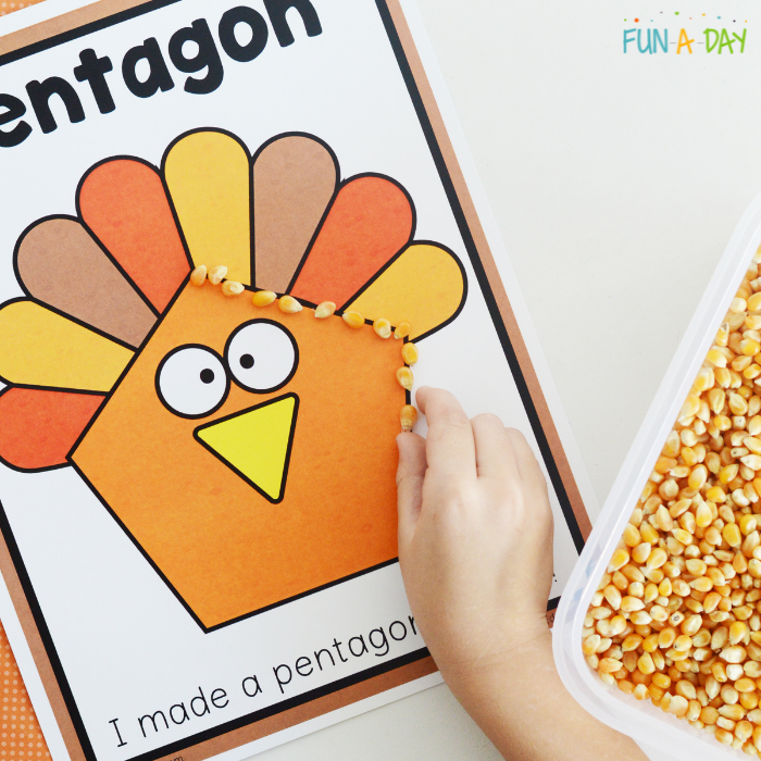 child outlining pentagon turkey with corn kernels