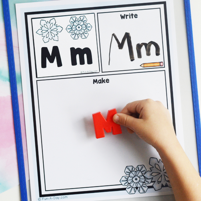 preschooler's hand adding letter M to winter read it build it write it printable