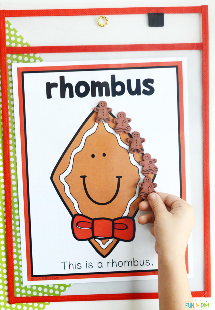 printable of a gingerbread rhombus shapes with child's hand interacting with it