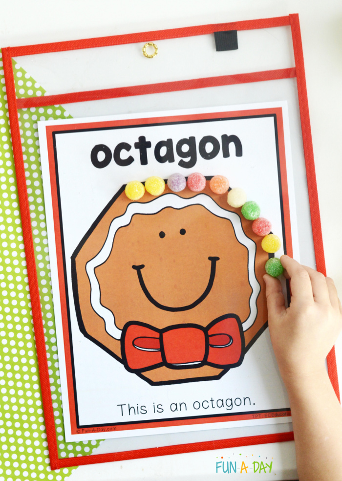 gingerbread face octagon shape on a preschool printable with child placing gumdrops around the perimeter