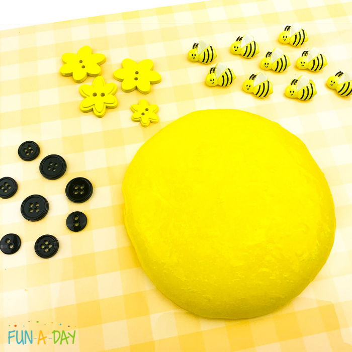 Yellow slime with groups of black, yellow flower, and bumblebee buttons.