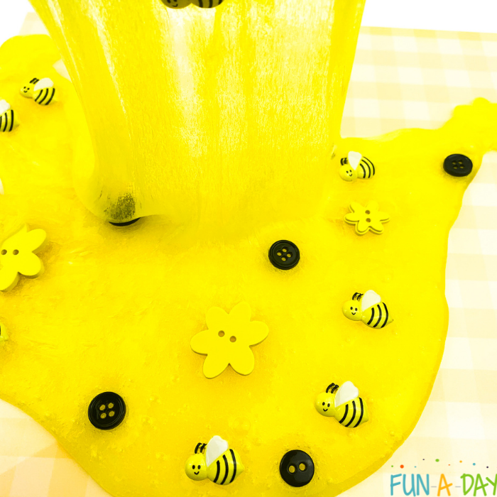 Yellow slime with black buttons, yellow flower buttons, and small bumblebees mixed throughout.