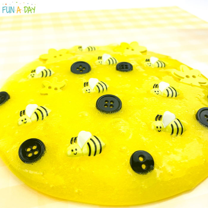 Yellow slime with black buttons, yellow flower buttons, and small bees scattered throughout.