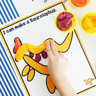 Person using play dough to make the shape of a saurolophus on the free printable mat.