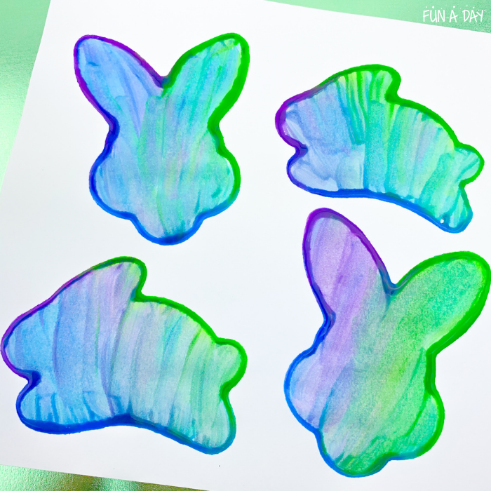 Purple, blue, and green painted bunny art.