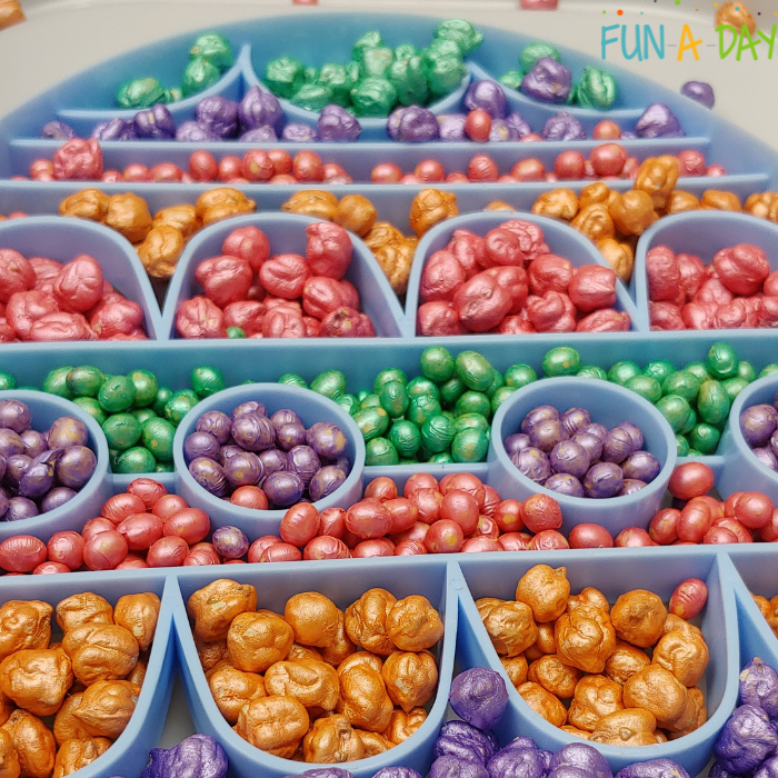 Close up of colorful chickpeas and soybeans inside a giant Easter egg cookie cutter