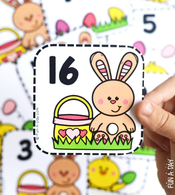 child holding Easter calendar number 16 with bunny on it