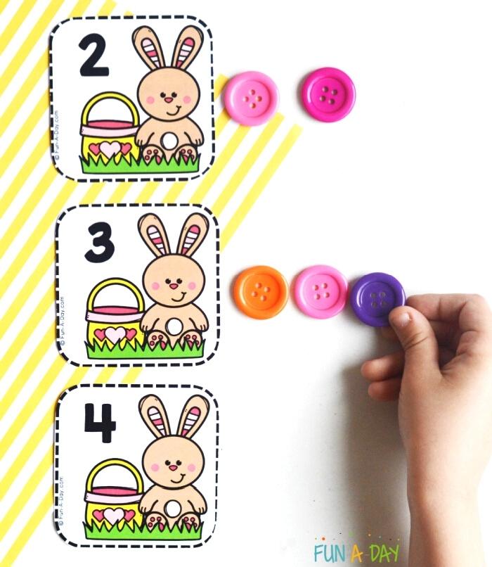 3 Easter calendar number cards with bunnies, plus child's hand with buttons