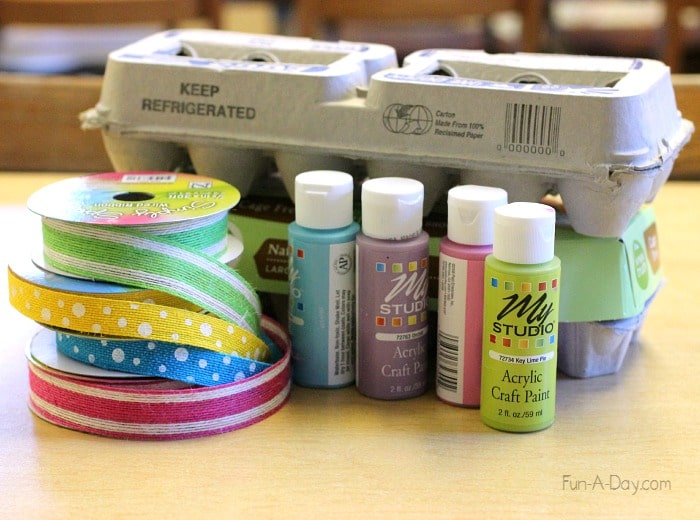Materials to make egg carton easter baskets, including egg cartons, ribbons, and paint
