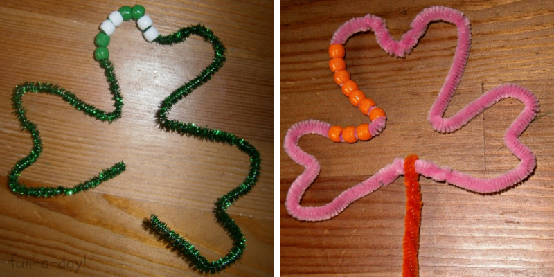 2 child-made pipe cleaner shamrocks with beads
