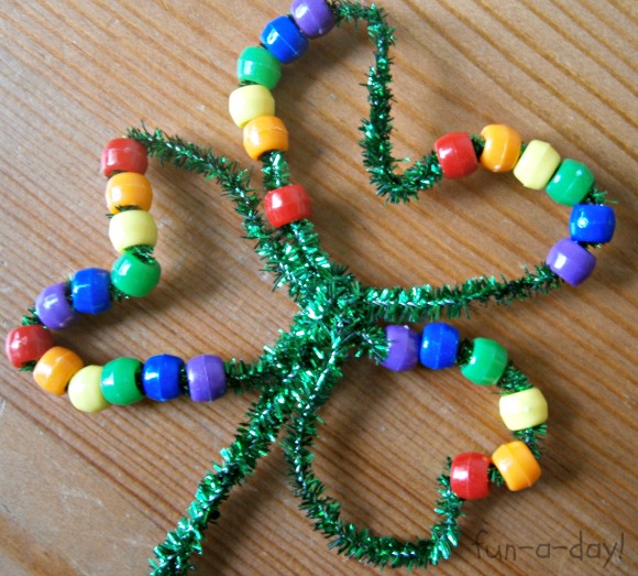 close up of beaded shamrock made with pipe cleaner and rainbow pony beads