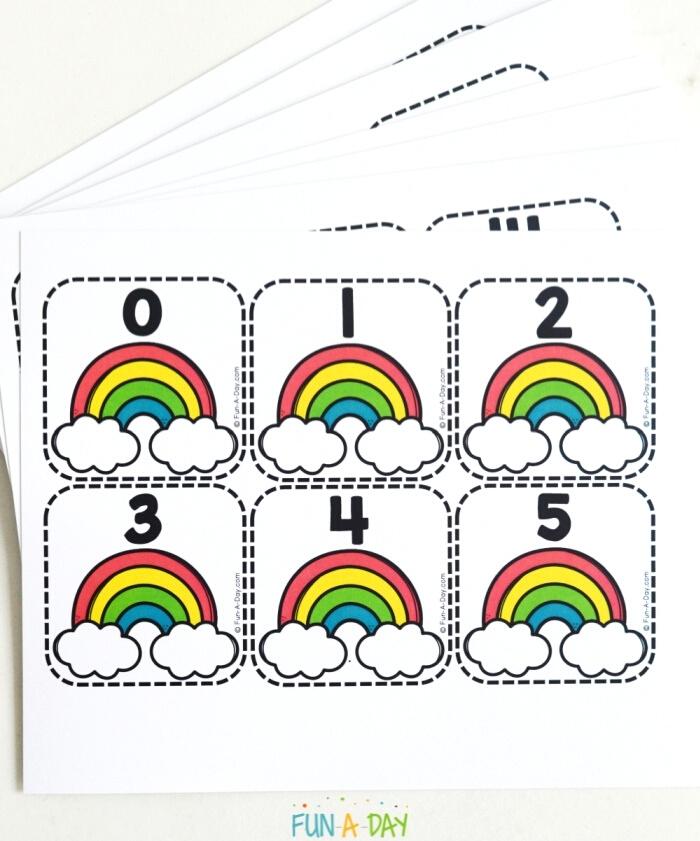 stack of spring number printables for preschoolers with rainbows and numbers
