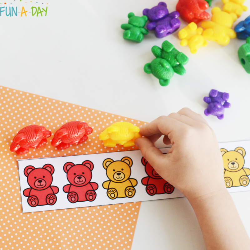 Preschooler using bear patterns with counting bears.