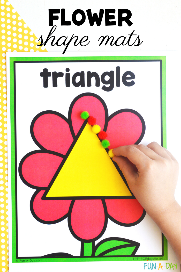 child's hand placing pom poms on a triangle flower shape with text that reads flower shape mats