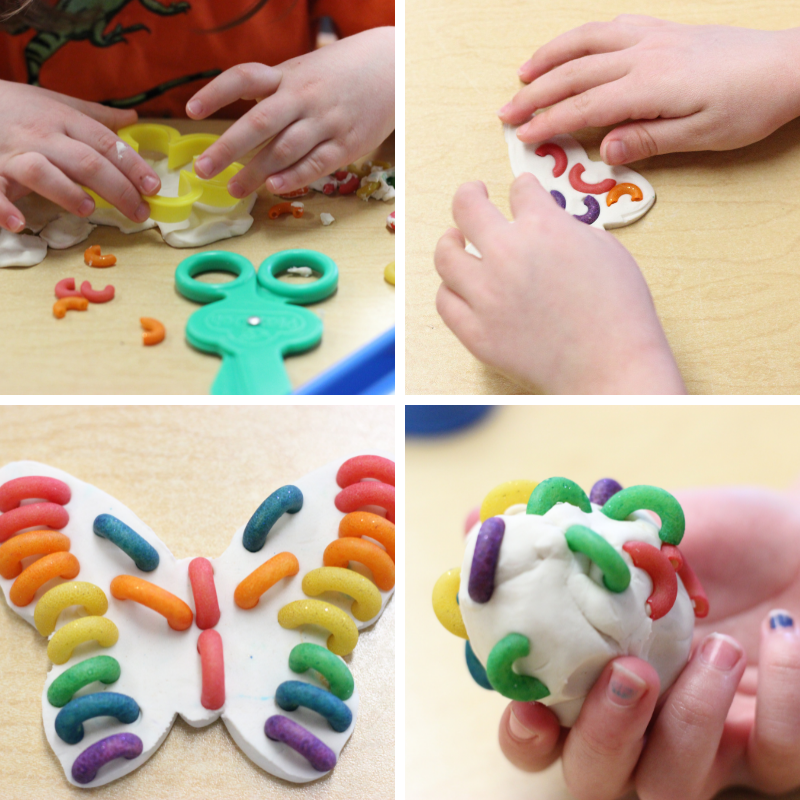 Preschoolers using white play dough and rainbow dyed macaroni.