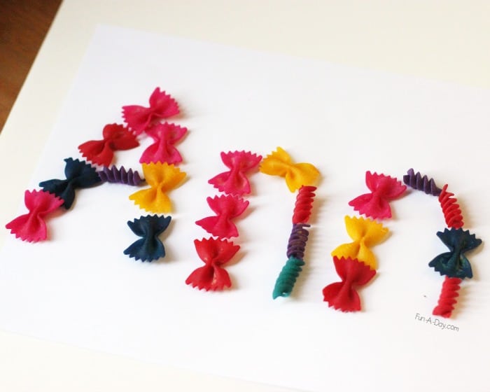 The name Ann spelled out using dyed pasta as part of butterfly name activities