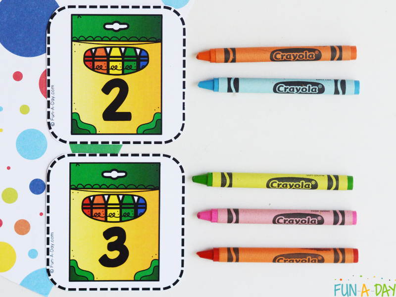 two crayon number cards with corresponding number of crayons next to each