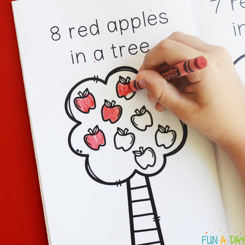 Child coloring in ten red apples printable book