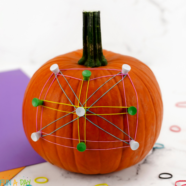 orange pumpkin geoboard with golf tees and rubber bands