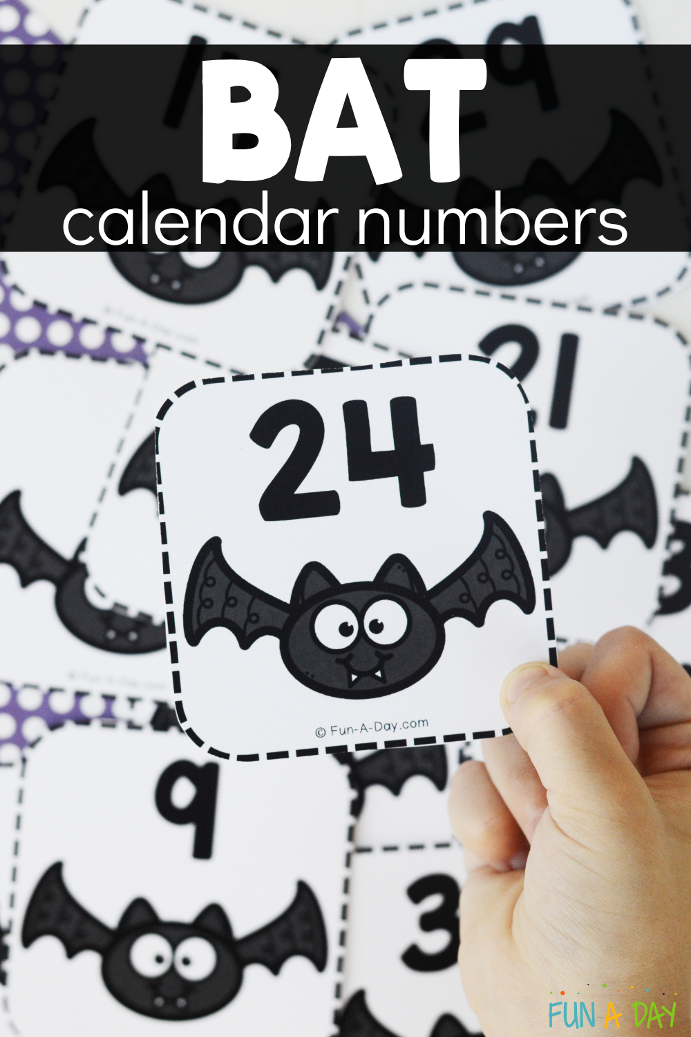 Child's hand holding bat number card with text that reads bat calendar numbers