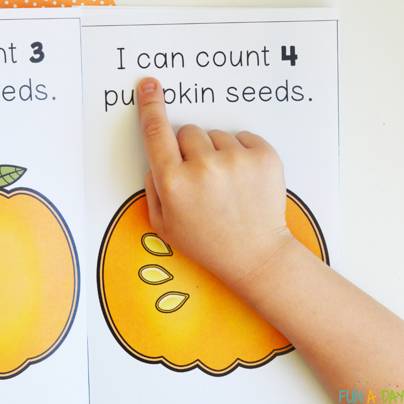 child's finger pointing to words in counting pumpkin seeds printable book