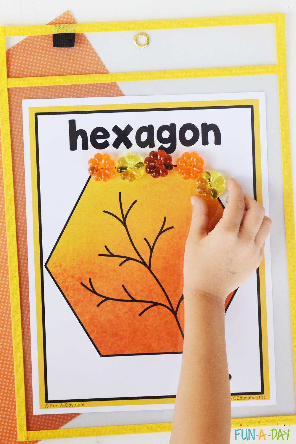 child placing acrylic pumpkins on hexagon leaf shape mat