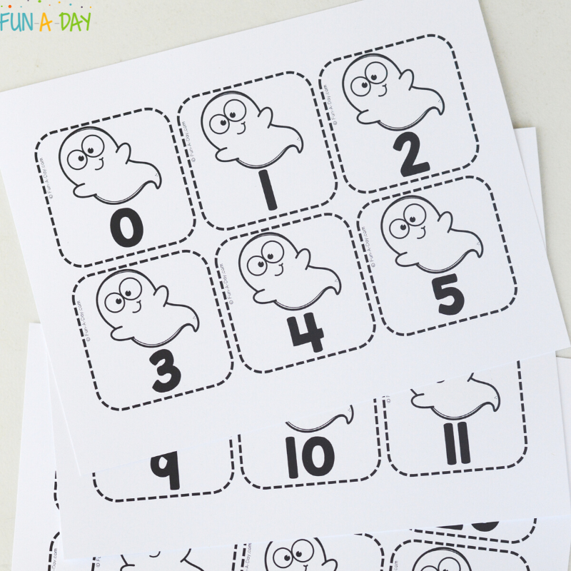 pile of printable ghost calendar numbers ready to be cut