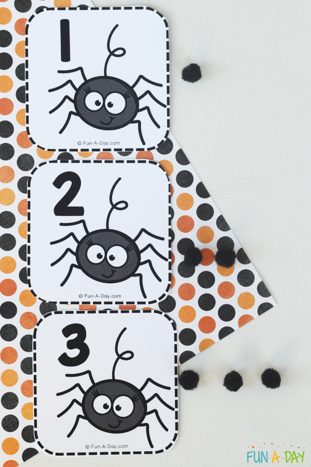 Spider calendar numbers 1, 2, 3 with corresponding number of black pompoms next to each
