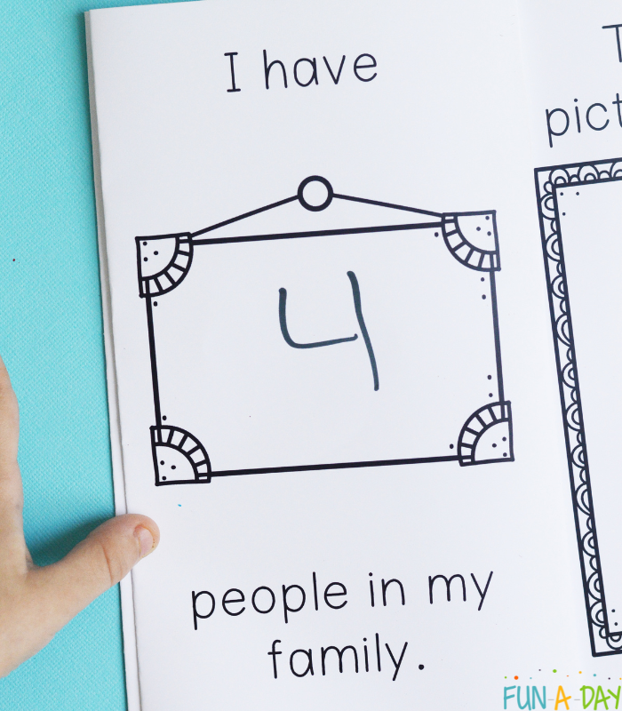 child holding all about me book printable to page about family
