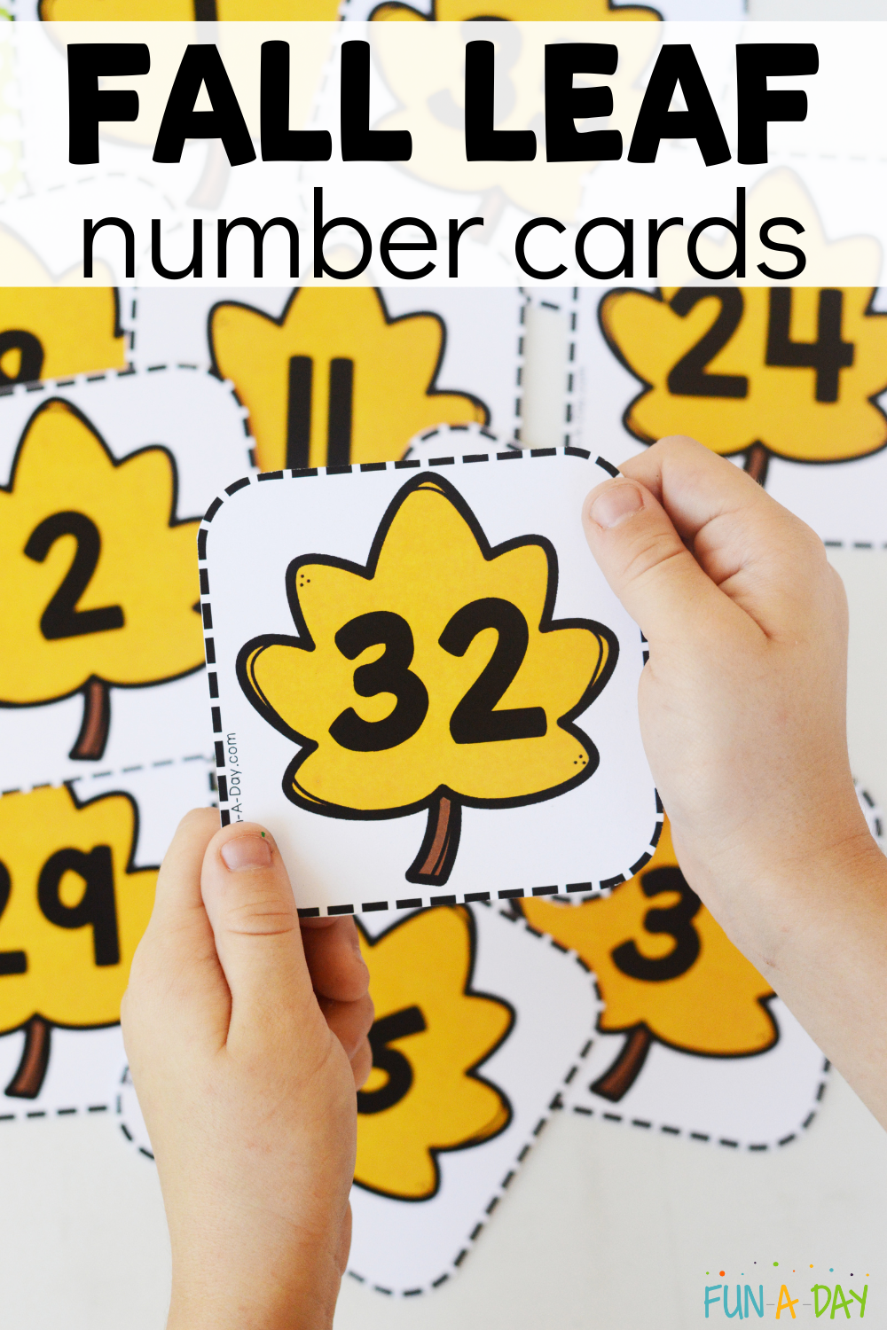 child holding number 32 over pile of leaf calendar numbers with text that reads fall leaf number cards