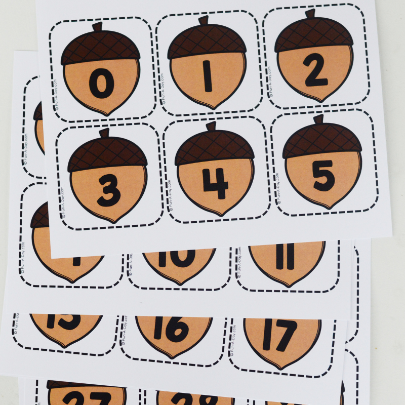 pile of uncut printable acorn calendar numbers