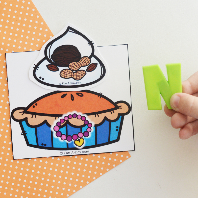 child holding letter N next to pumpkin pie beginning sound matching cards