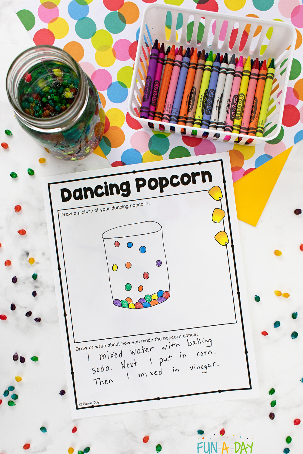 Crayons, jar of hopping corn kernels, and dancing popcorn science recording sheet