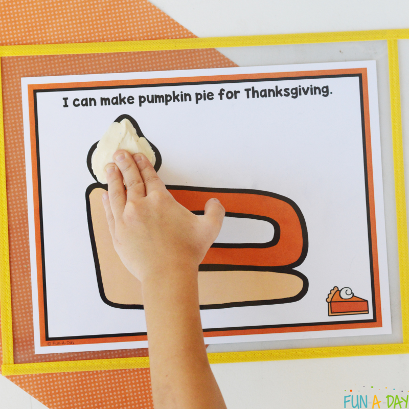 preschooler using pumpkin pie playdough mat