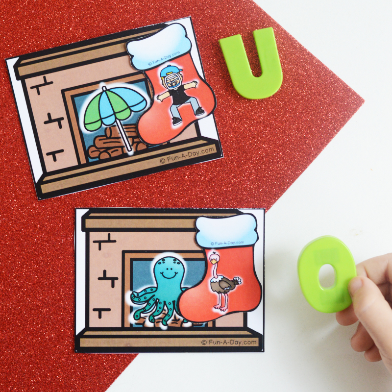 child's hand matching magnetic letters to christmas stockings beginning sounds printable