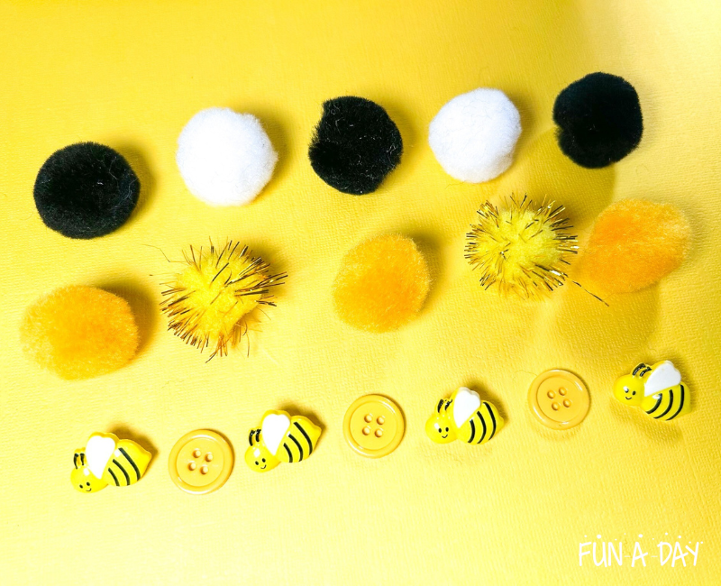 pompoms, yellow buttons, and bee buttons from a bee sensory bin in patterns