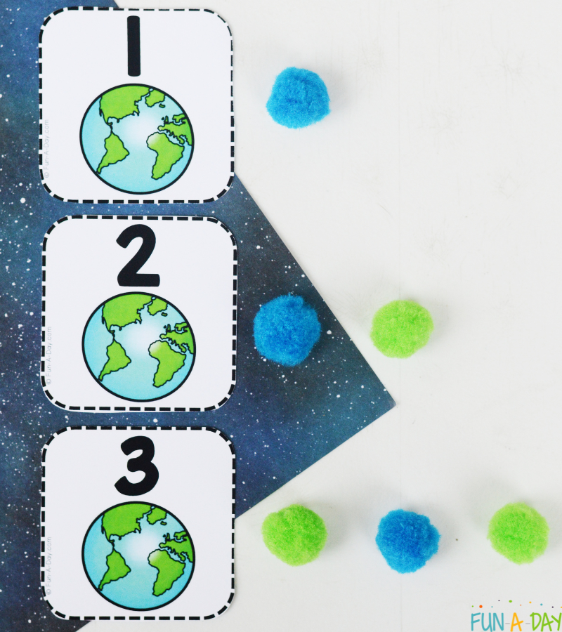 earth calendar numbers 1, 2, and 3 with corresponding number of pompoms next to each